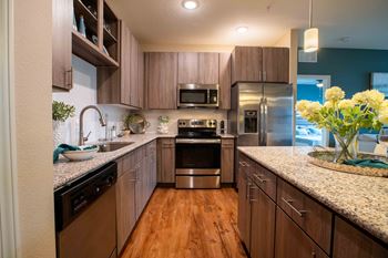 A kitchen with wooden cabinets and stainless steel appliances